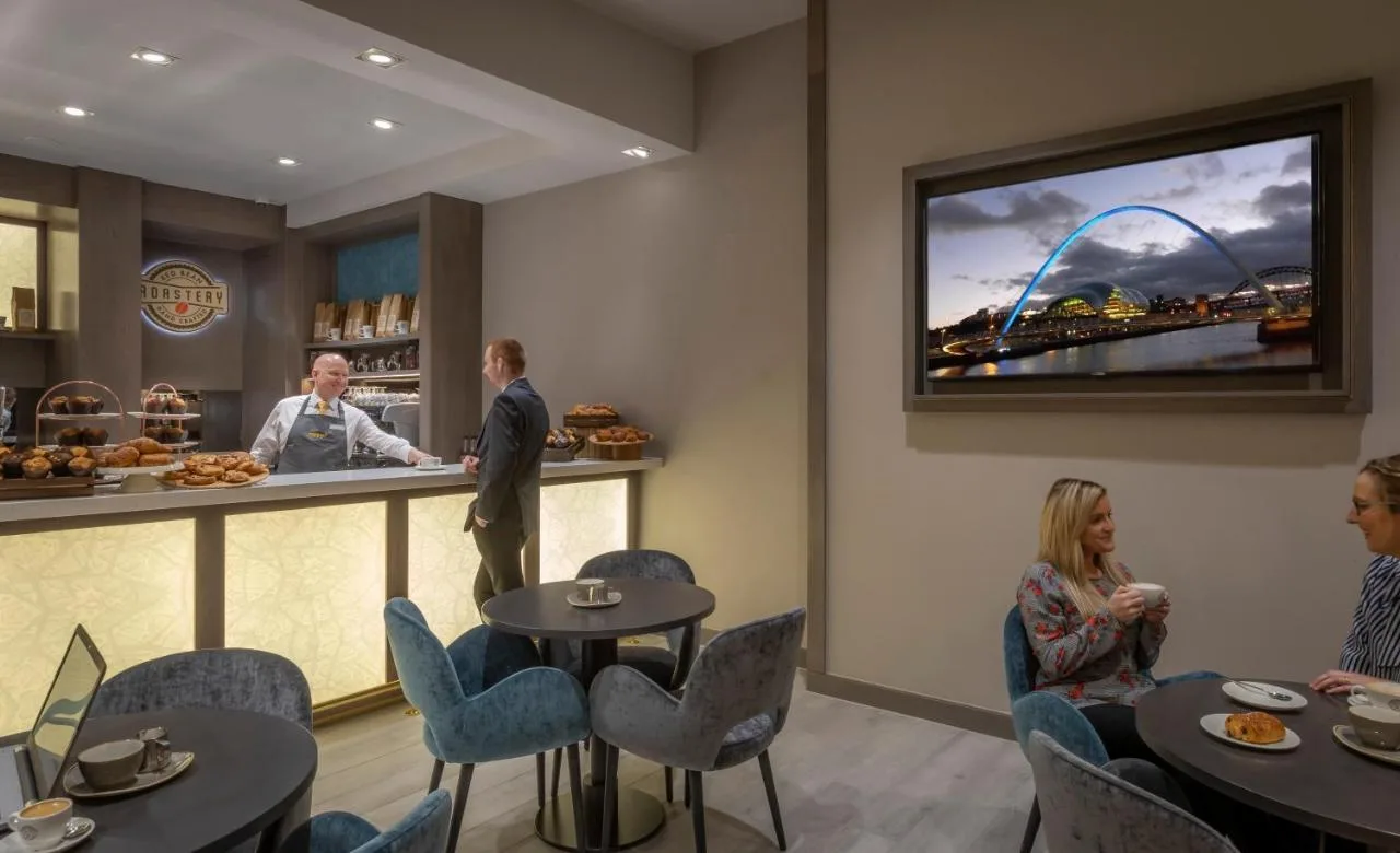 a restaurant with people waiting at the counter at Maldron Hotel Newcastle in Newcastle upon Tyne